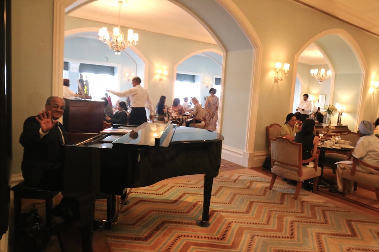 Pianist plays on a grand piano at Taj Mahal Palace Hotel Mumbai's High Tea.