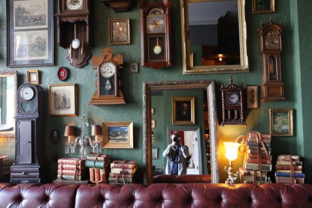 Vintage clocks and mirrors cover the walls at The Good Son Toronto.