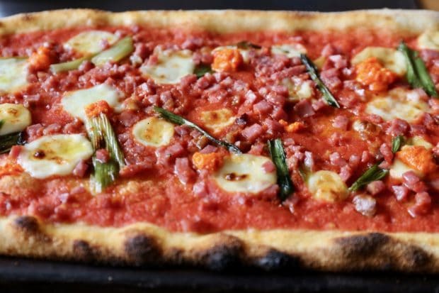 Buca offers slender thin-crust pizza for delivery in downtown Toronto.