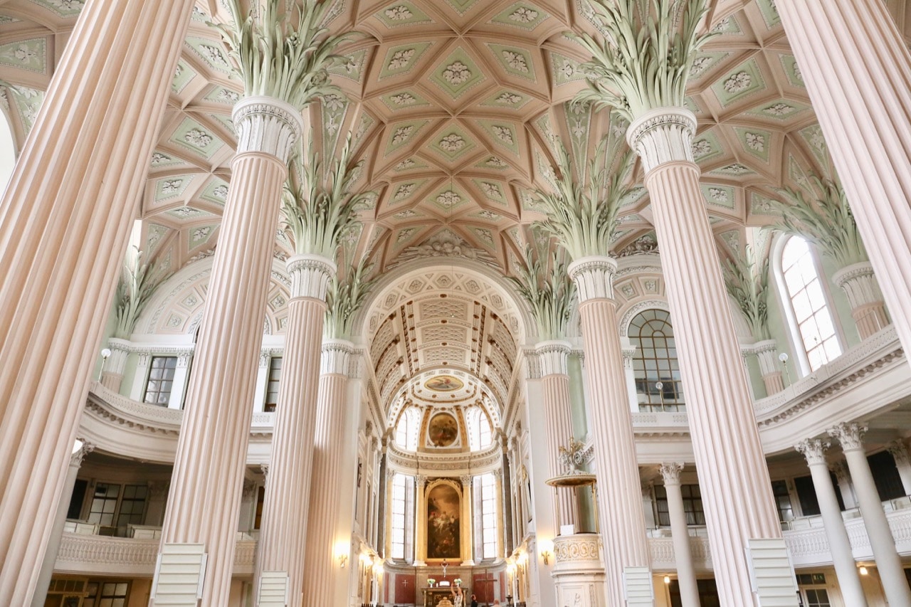 Pink and green ornate interior at St Nicholas Church. 