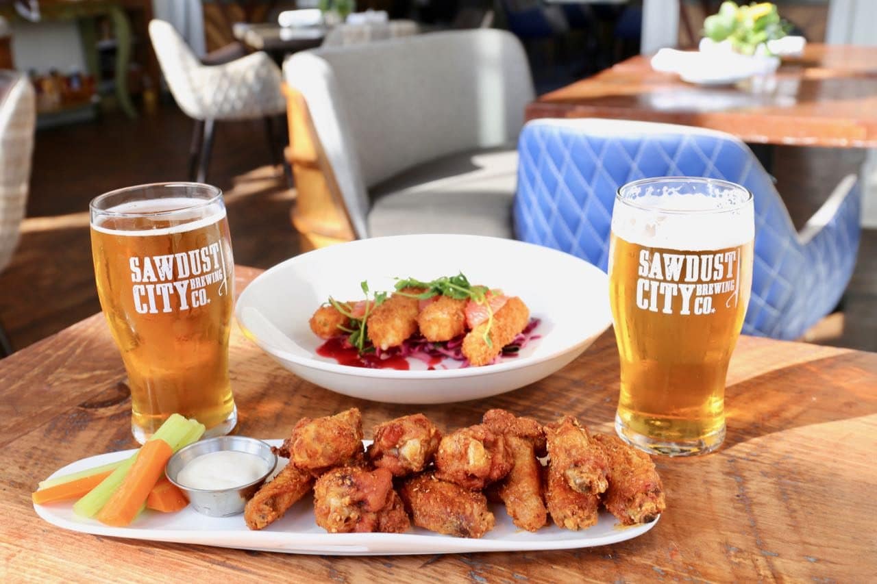 Sip Muskoka craft beer alongside a plate of chicken wings at Lakes Bar.
