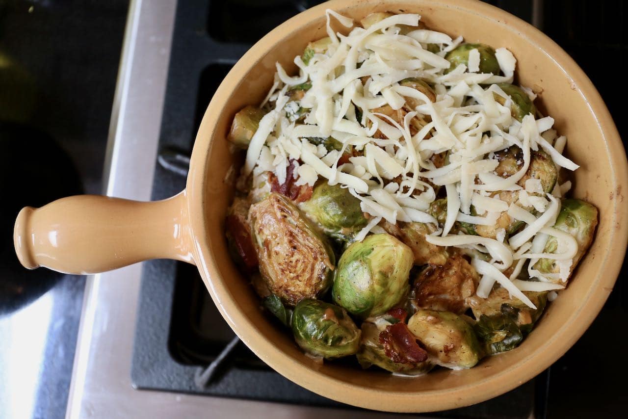 Bake Keto Brussels Sprouts in a casserole dish toped with shredded mozzarella.