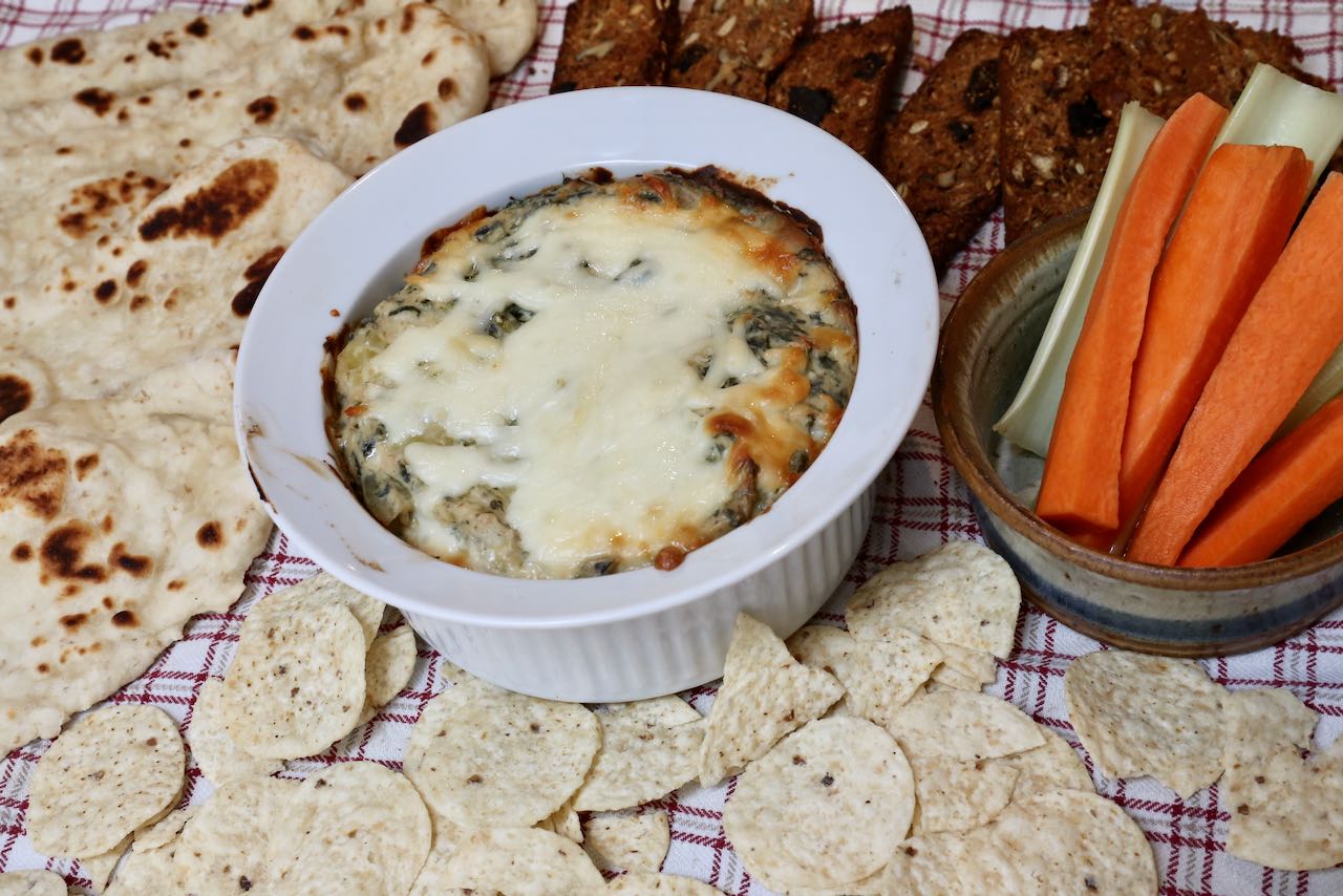 Serve Keto Spinach Dip with nachos, flatbread, crackers and carrot sticks.