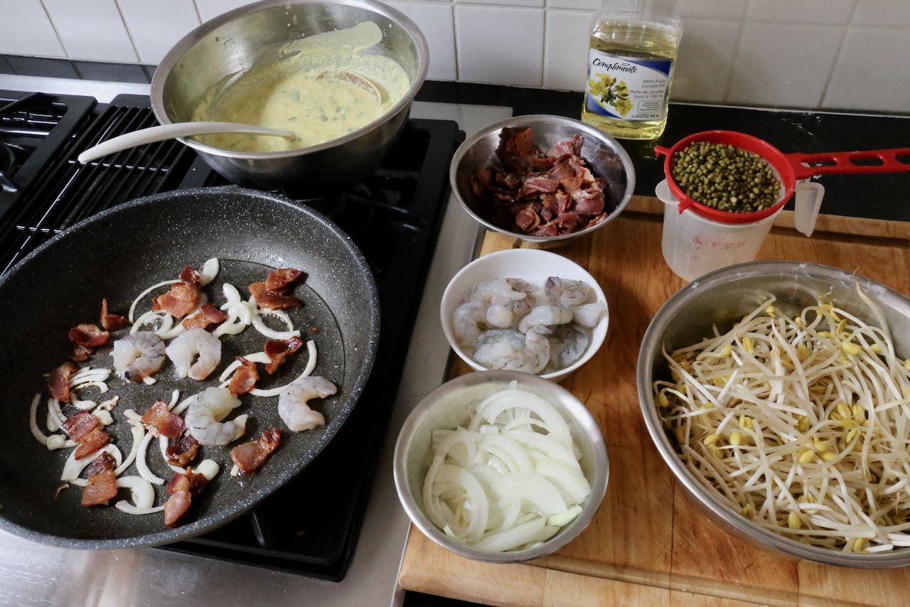 Vietnamese  Crepe Step 1: Fry onion, bacon and shrimp in non-stick pan over medium heat.