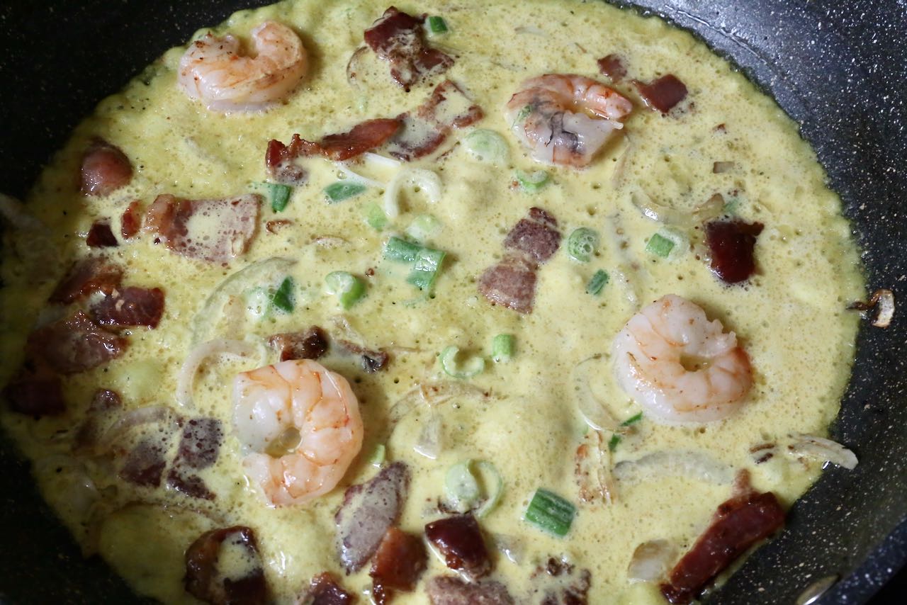 Vietnamese Crepe Step 2: Add a ladle full of Vietnamese crepe batter. 