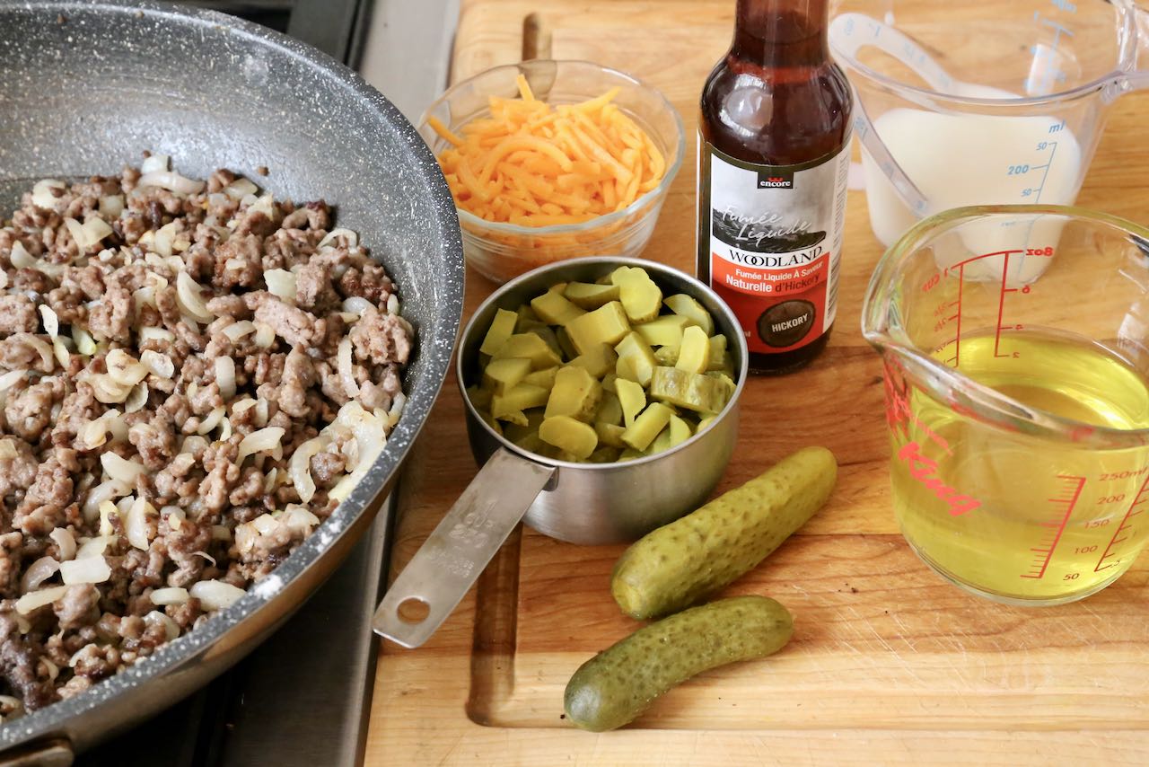 Measure chopped pickles, cheese, liquid smoke, pickle juice and milk.