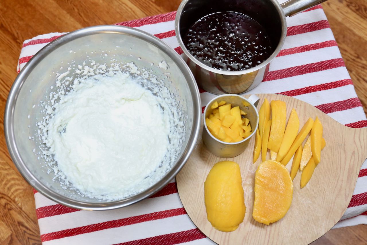 Begin by preparing your cottage cheese filling, blueberry sauce and sliced mangos. 