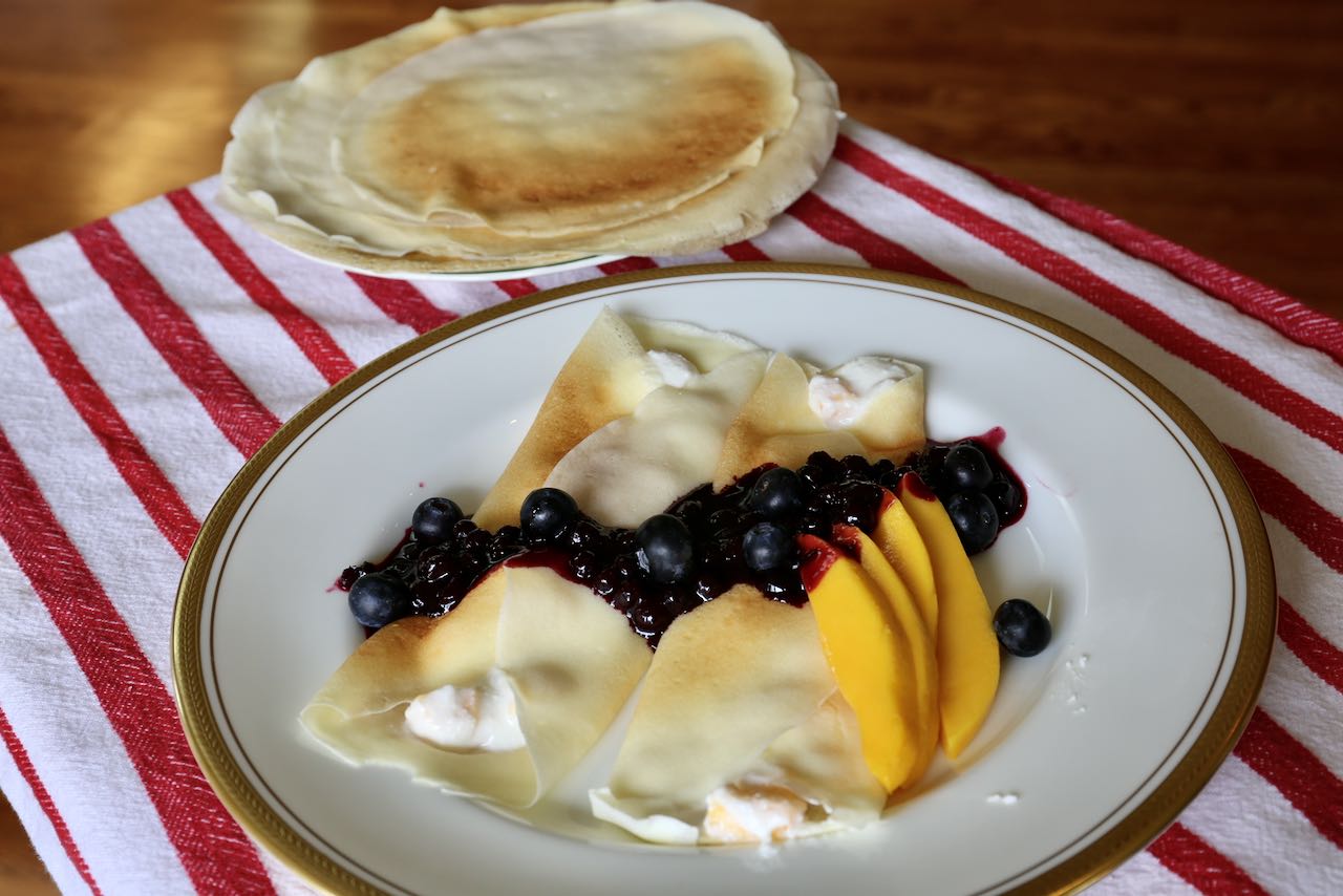Stuff crepes with coconut flour with mango cottage cheese and top with blueberry sauce.