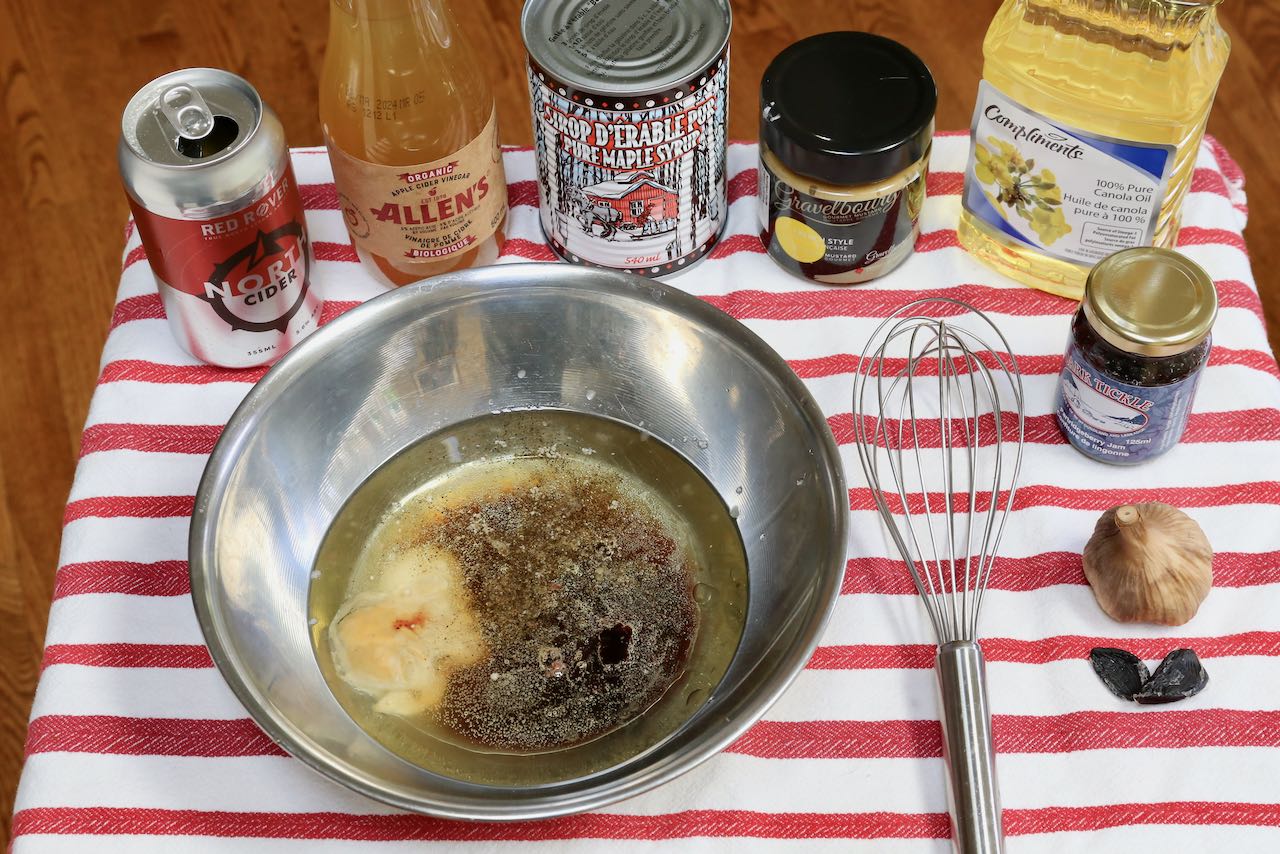 Preparing Canadian Salad dressing with a whisk and mixing bowl.