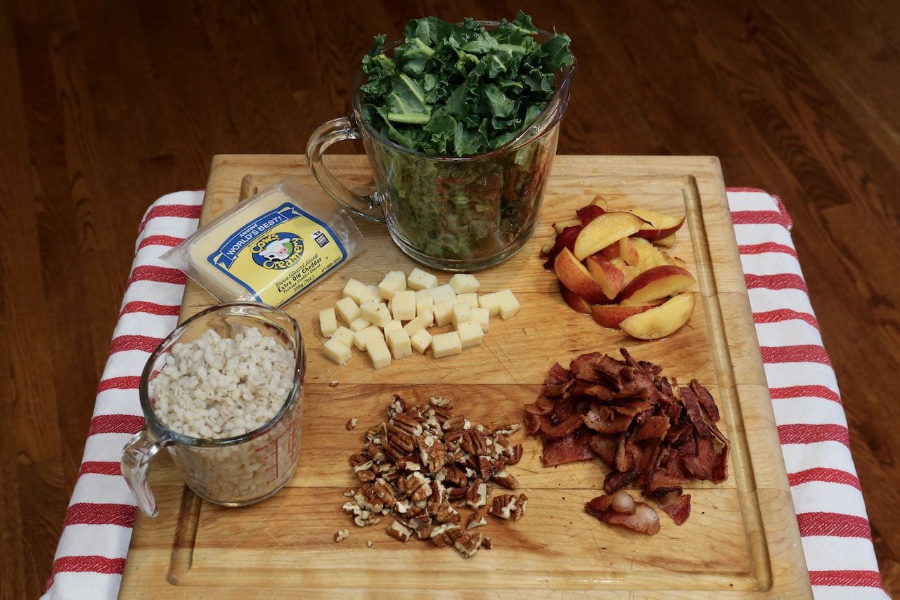 Canadian Salad: Chopped kale, cheese cubes, cooked barley and sliced pecans, bacon and peaches.
