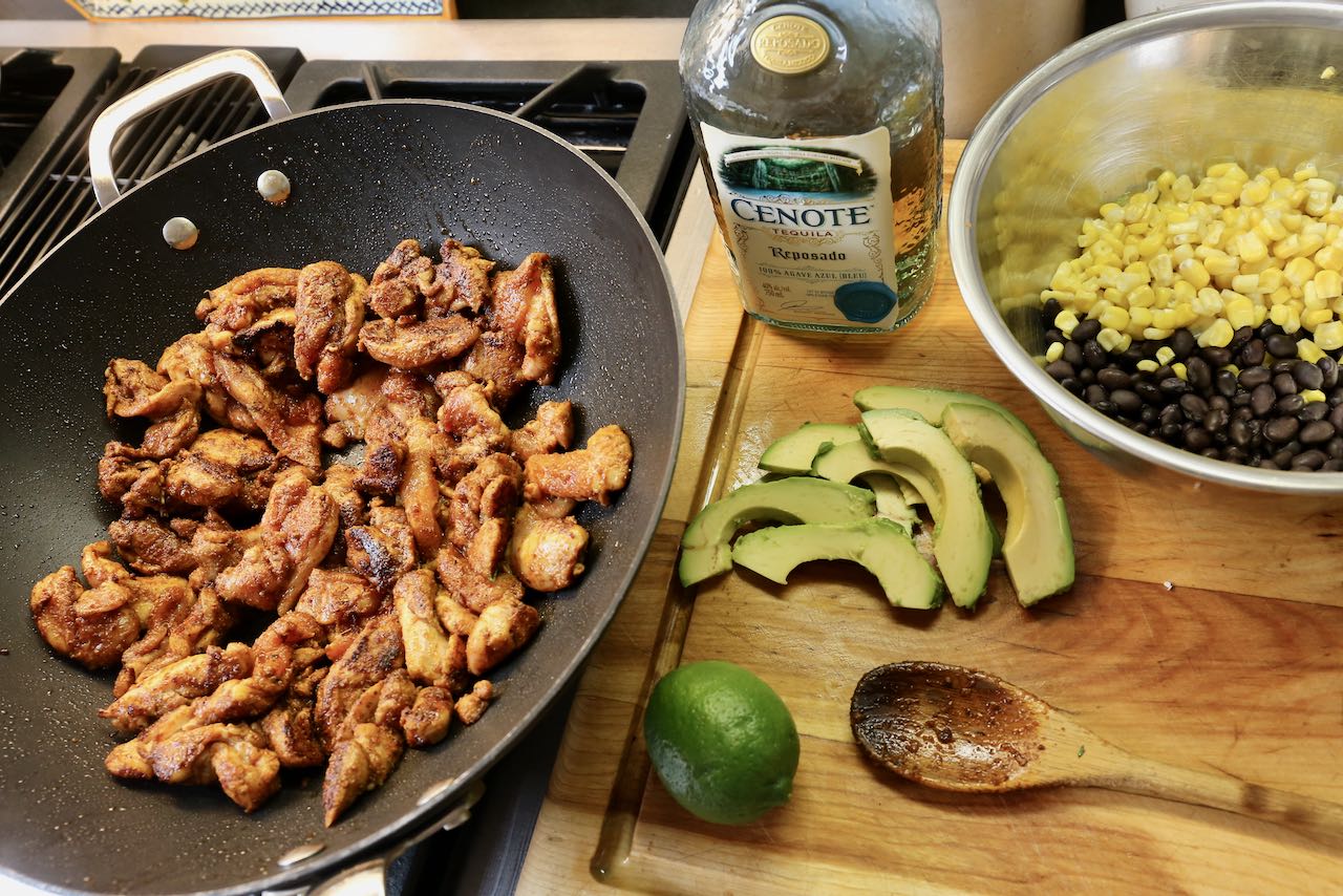 Prepare the filling for chicken fajita tacos in a wok or large non-stick skillet.