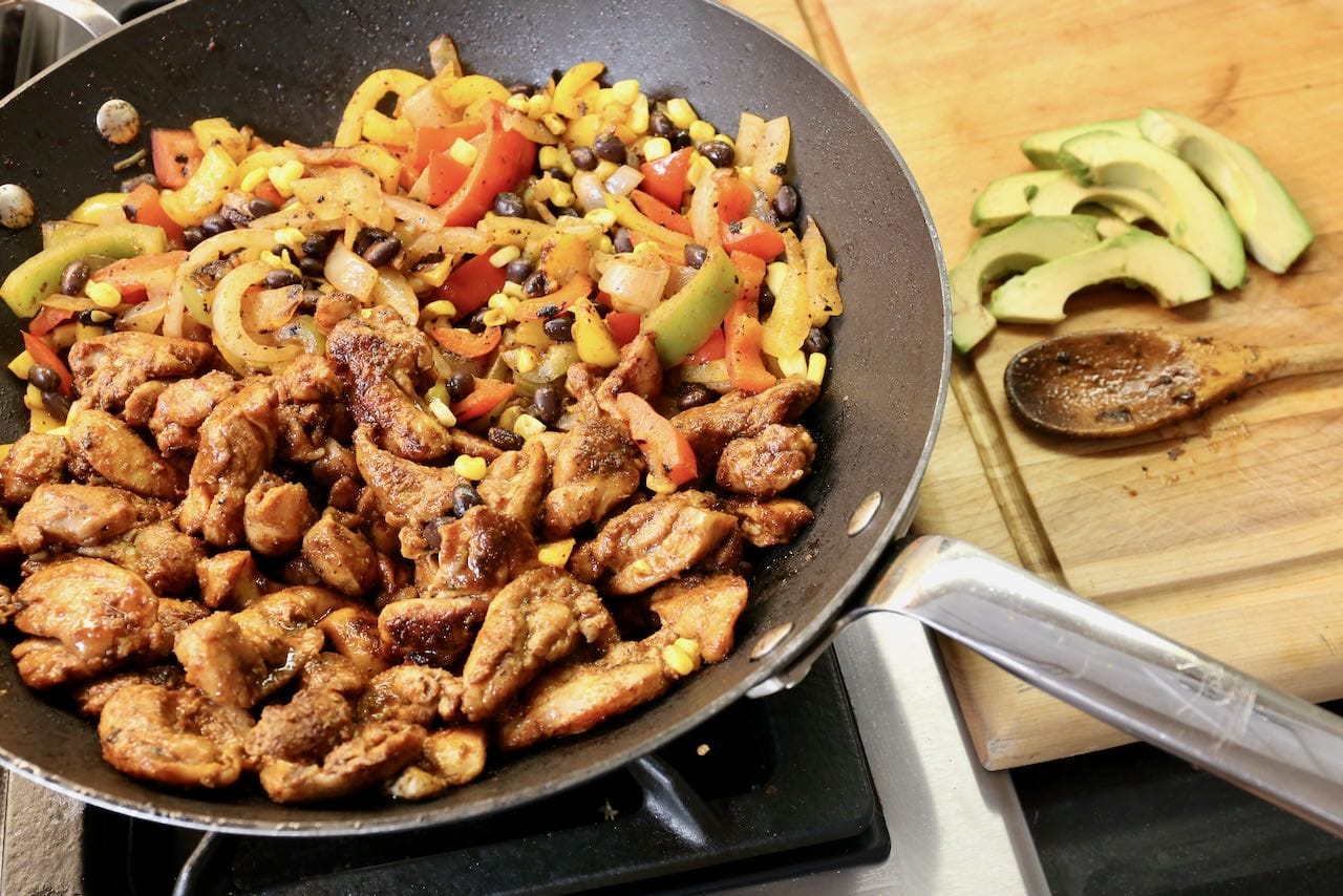 Cook chicken, beans, corn and marinated vegetables until tender.