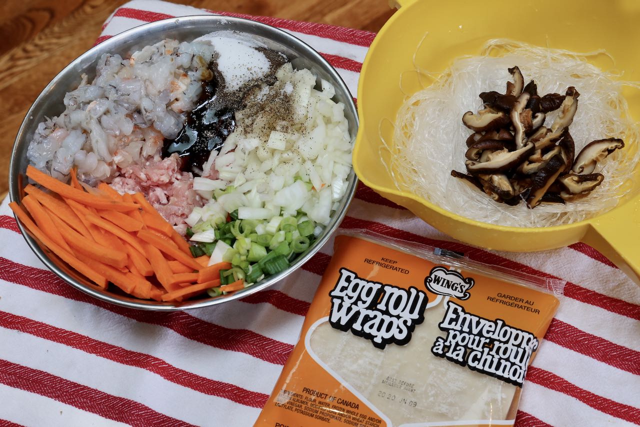 Prepare the filling by chopping vegetables, slicing shrimp, soaking noodles and hydrating dried mushrooms.