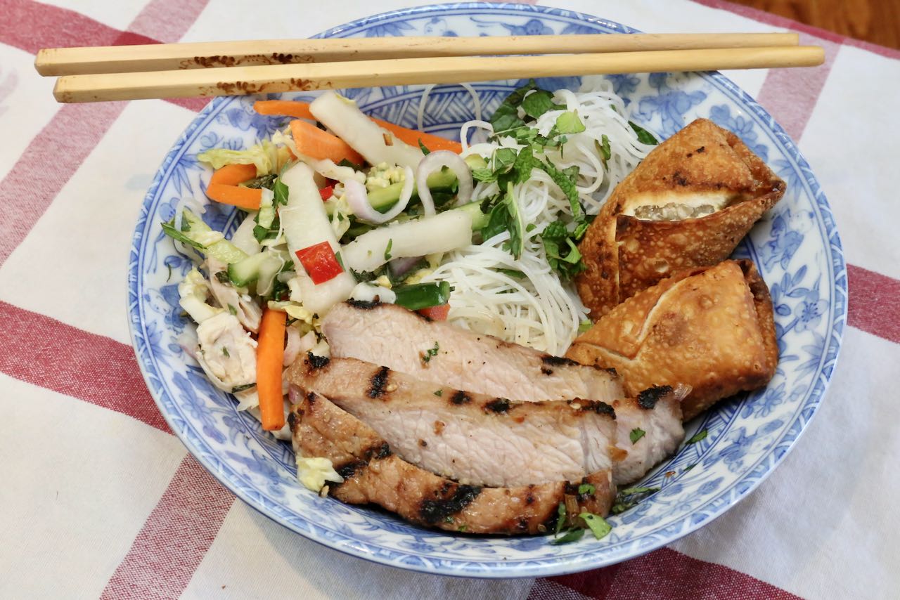Serve Bun Thit Nuong with rice noodles, pickled vegetables and Vietnamese egg rolls.