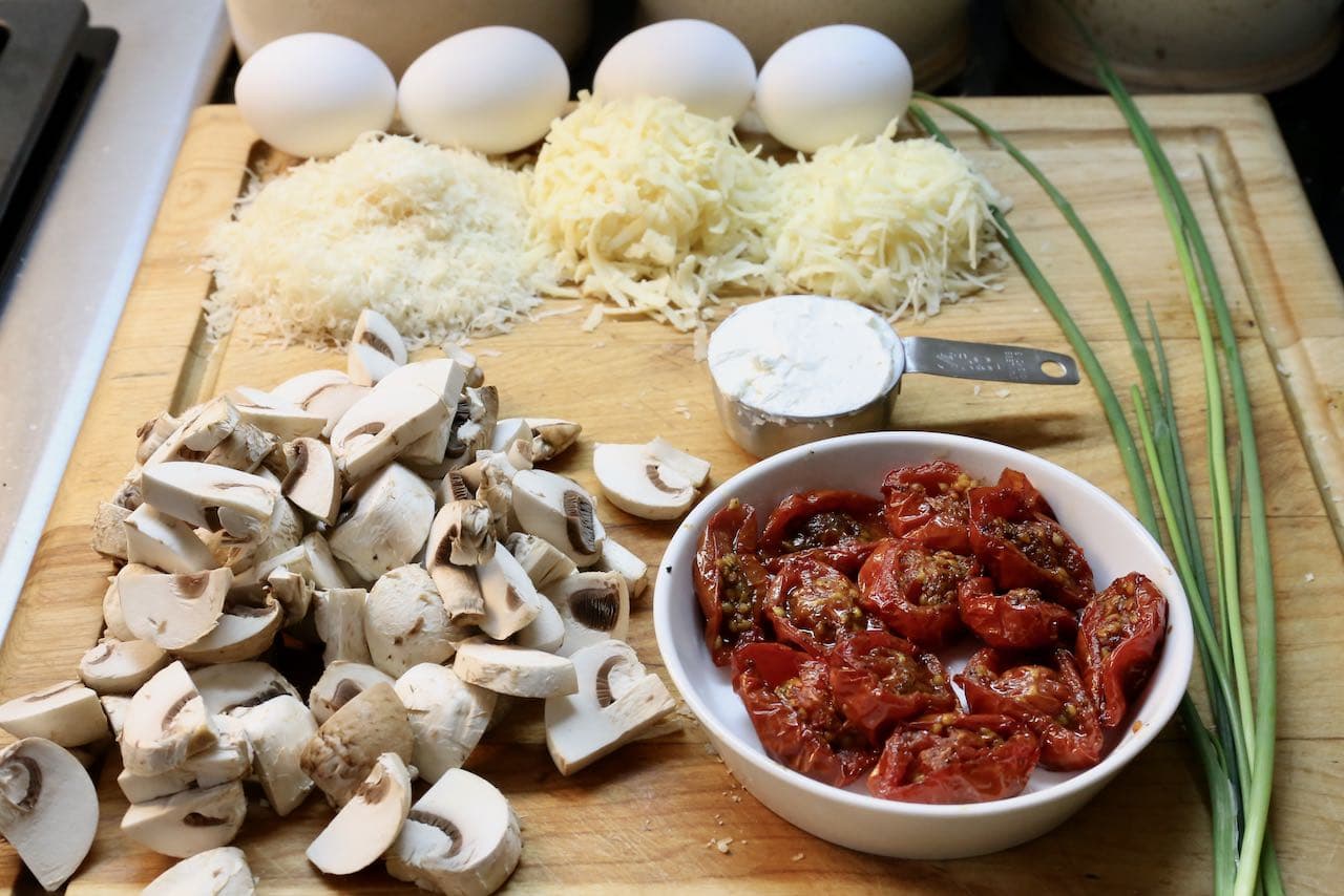 Breakfast Polenta features shredded cheeses, roasted tomatoes, mushrooms and fried eggs.