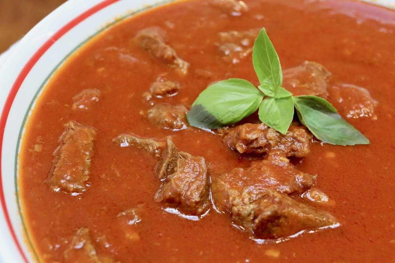 Serve Instant Pot Short Rib Ragu family style topped with fresh basil.