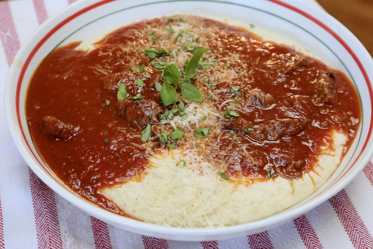 Serve Instant Pot Short Rib Ragu over creamy polenta topped with parmesan cheese. 