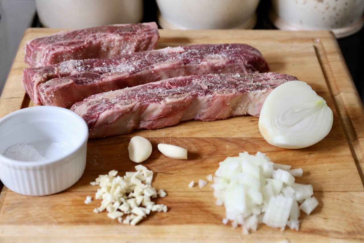 Season short rib with salt and mincing garlic and onion. 