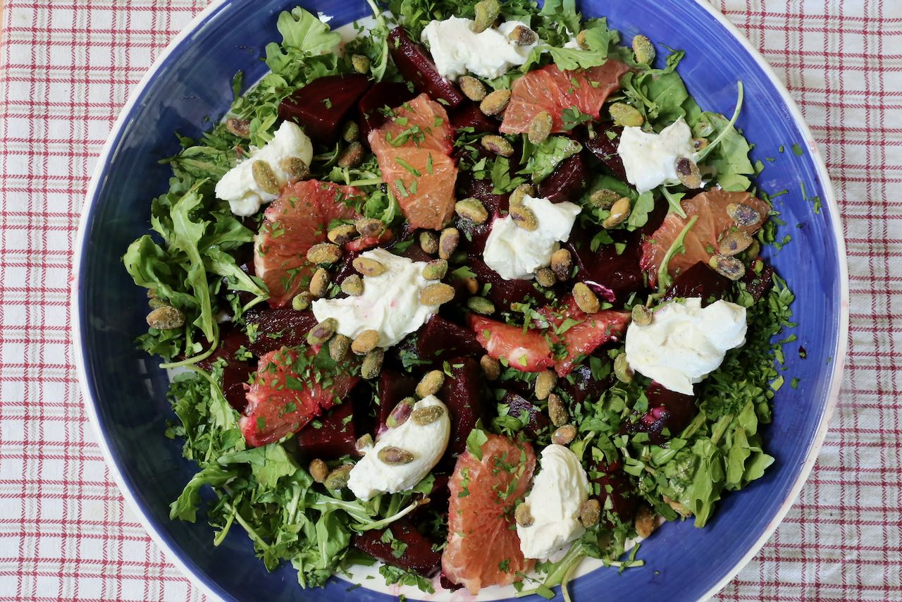 Serve Roasted Beet Salad family style topped with chopped herbs and pistachio.