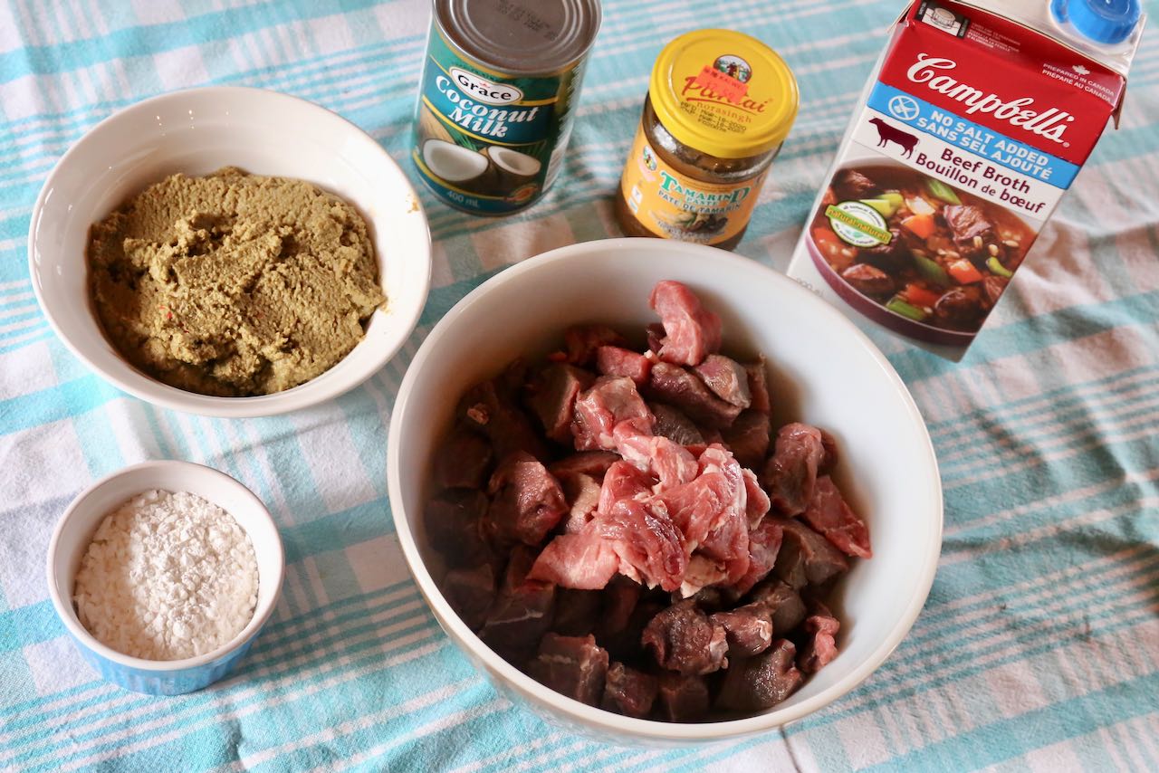 Begin Gaeng Masaman preparation by slicing beef and tossing in cornstarch.