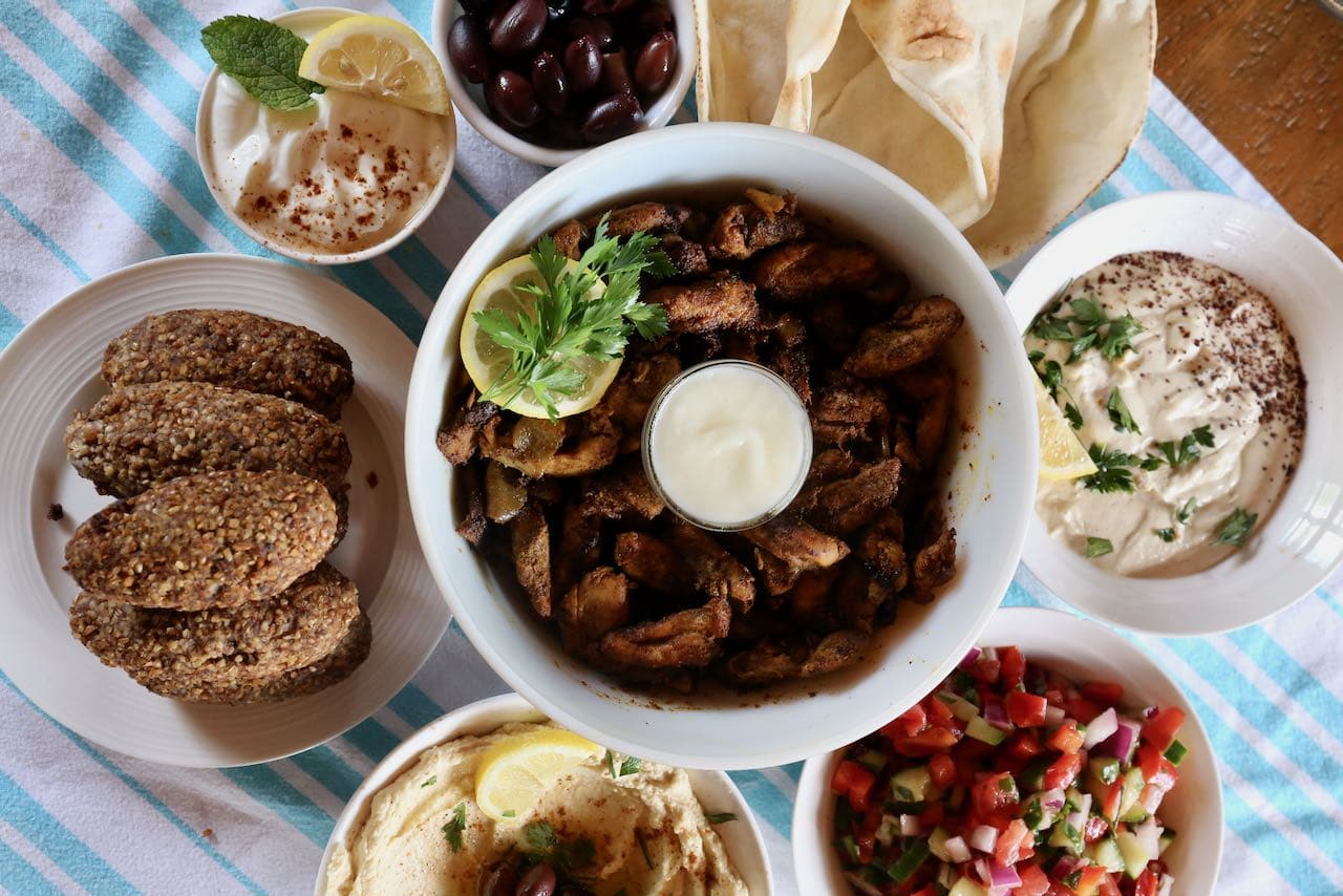 Include toum, kibbeh, hummus, olives and fresh salads on your Chicken Shawarma Platter.