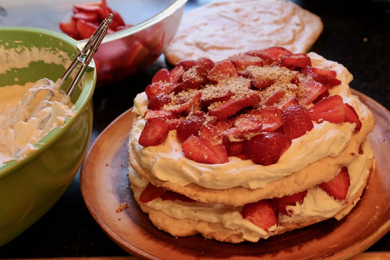 Sprinkle ground almonds on Swedish Strawberry Midsommar Cake.