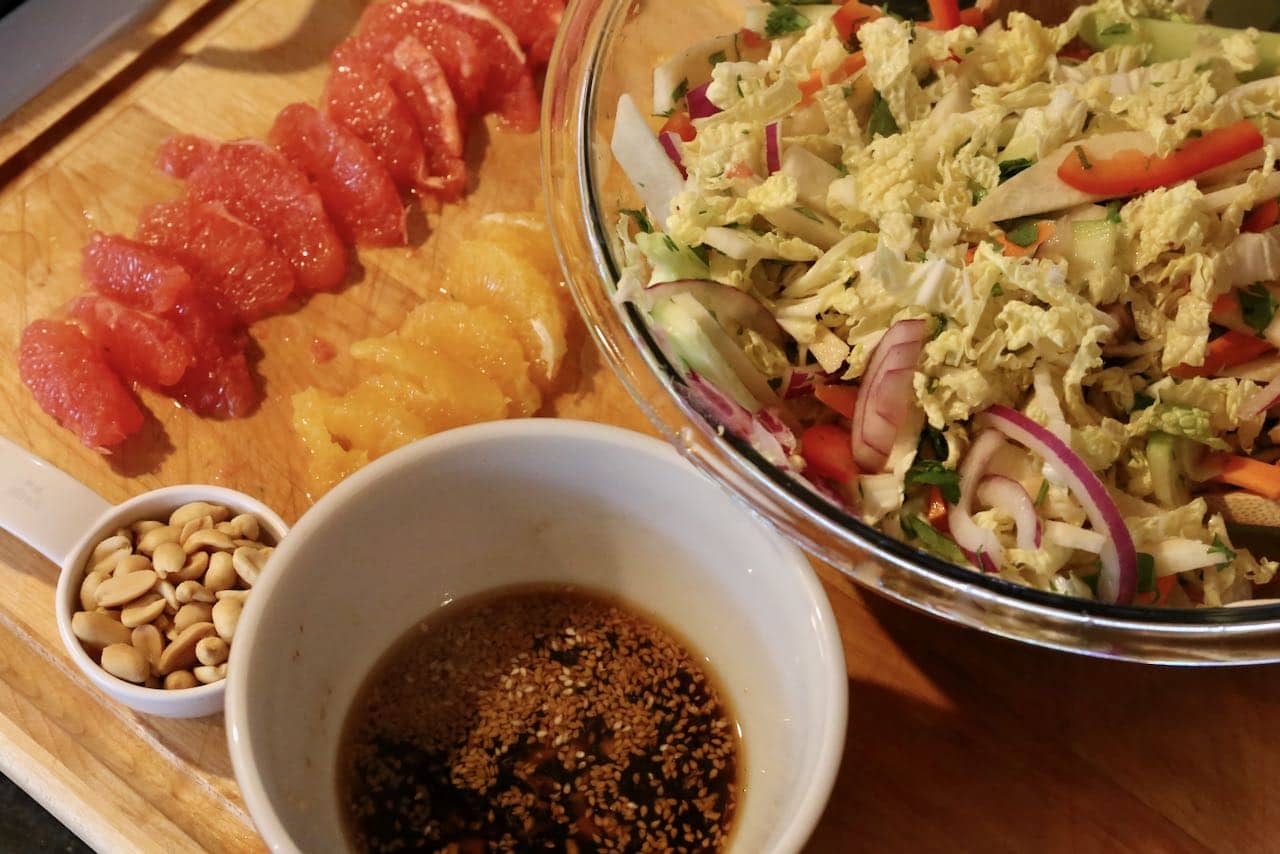 Toss Singapore Salad with dressing and top with grapefruit, orange and peanuts.