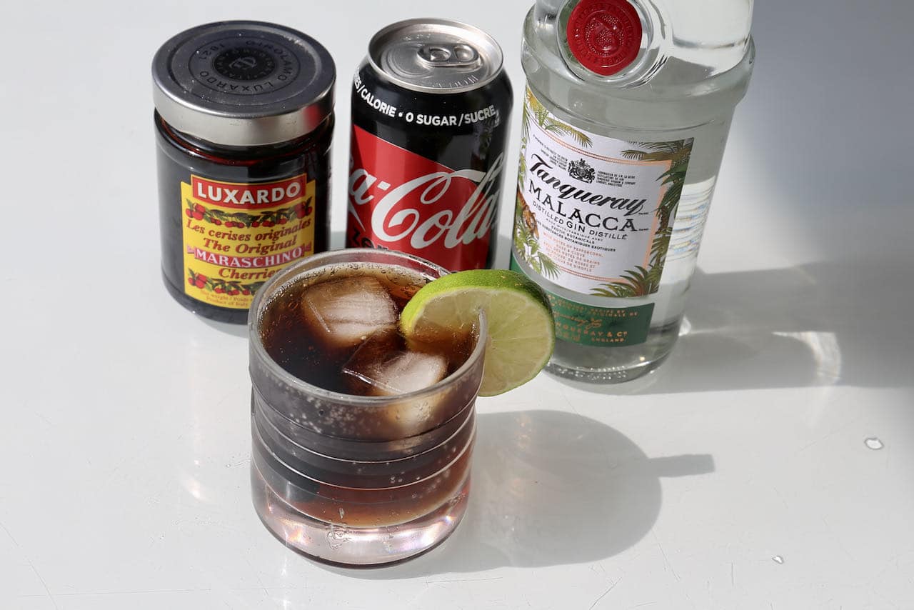 Muddle Coca Cola with premium gin and top with lime and Luxardo cherry.
