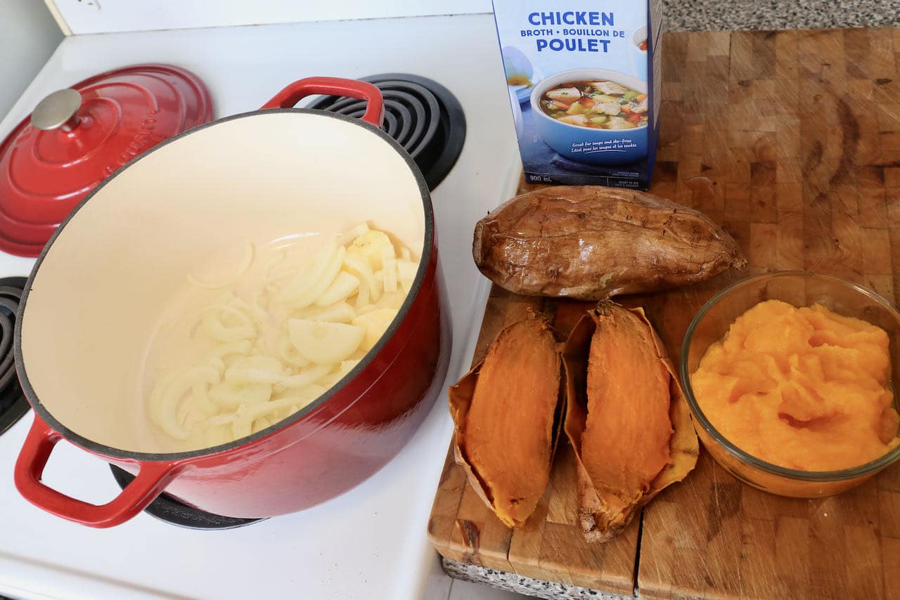 In a Dutch Oven start preparing Pumpkin and Sweet Potato Soup with butter and sliced onions.
