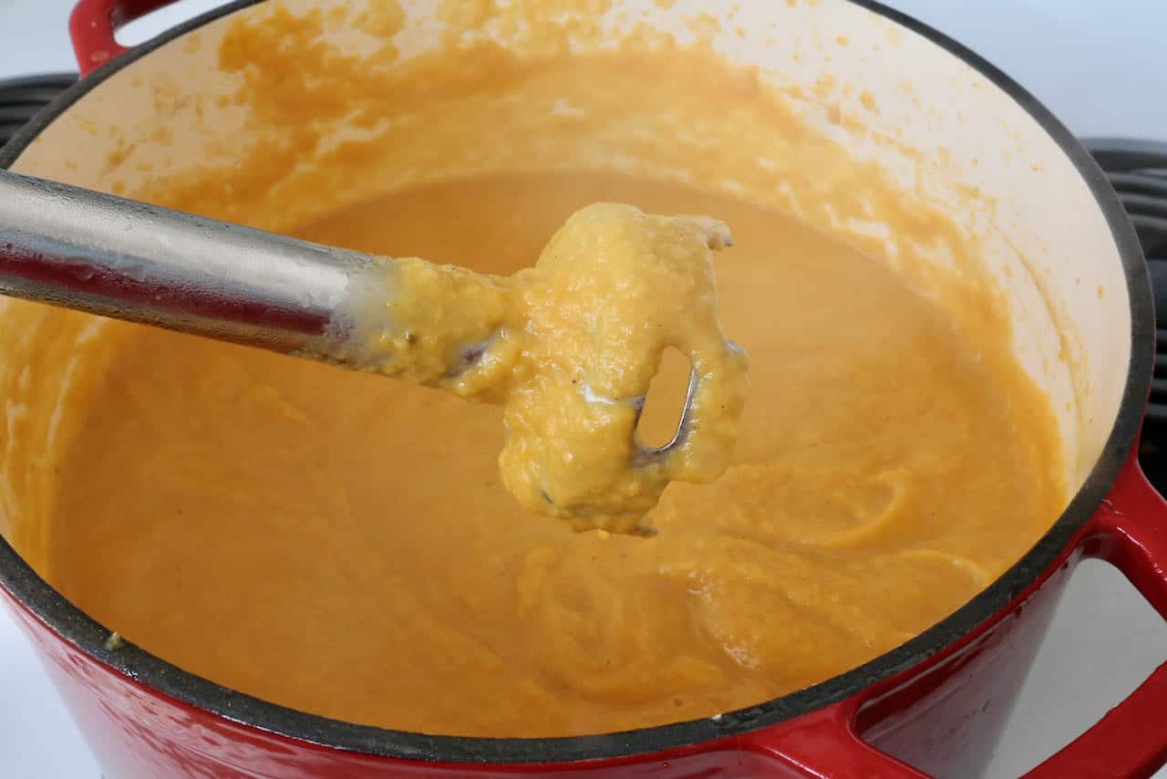 Blitz Pumpkin and Sweet Potato Soup with an immersion blender until smooth and silky.