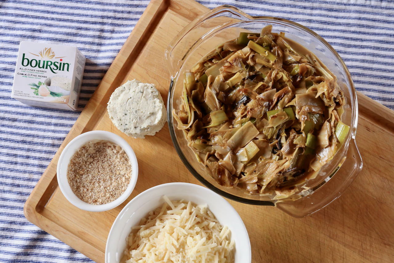 Top cooked leeks with shredded cheese, dabs of Boursin cream cheese and sprinkle of bread crumbs.
