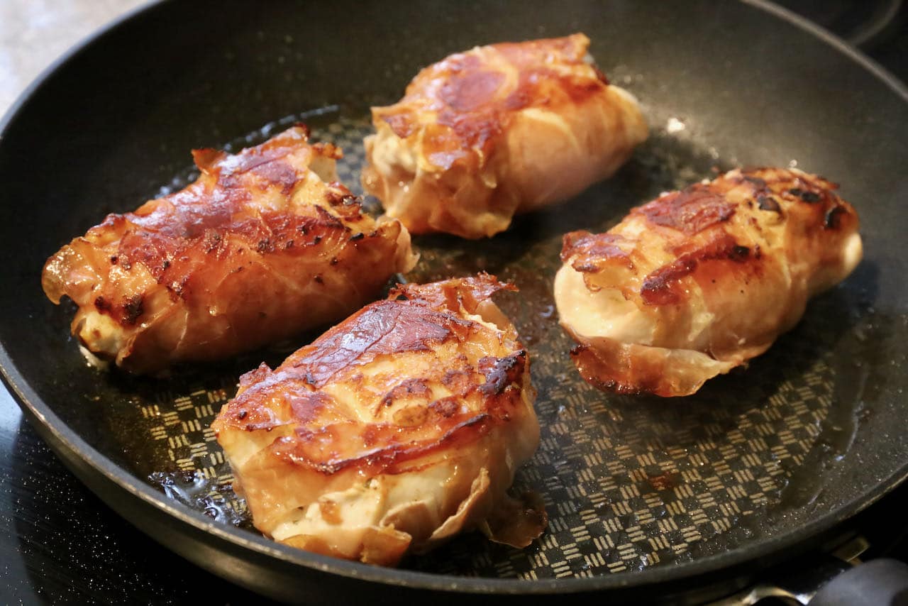 You know Involtini di Pollo are finished cooking when the prosciutto is browned and crispy.