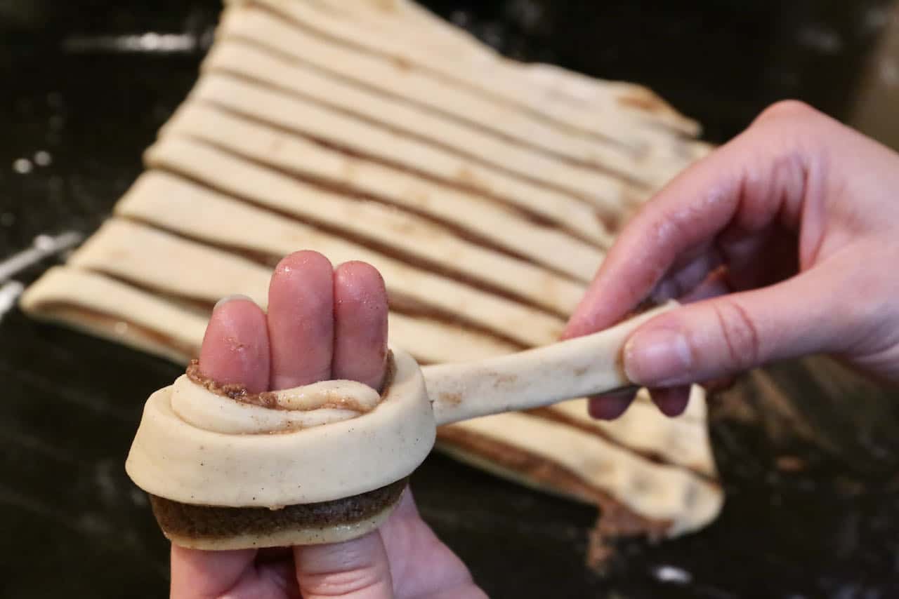 Form Swedish Cardamom Buns by twisting dough strip around your fingers into a knot shape.