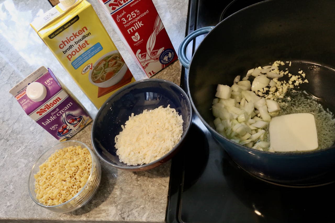 Begin cooking Ditalini Soup by frying garlic and onions in butter in a large pot.