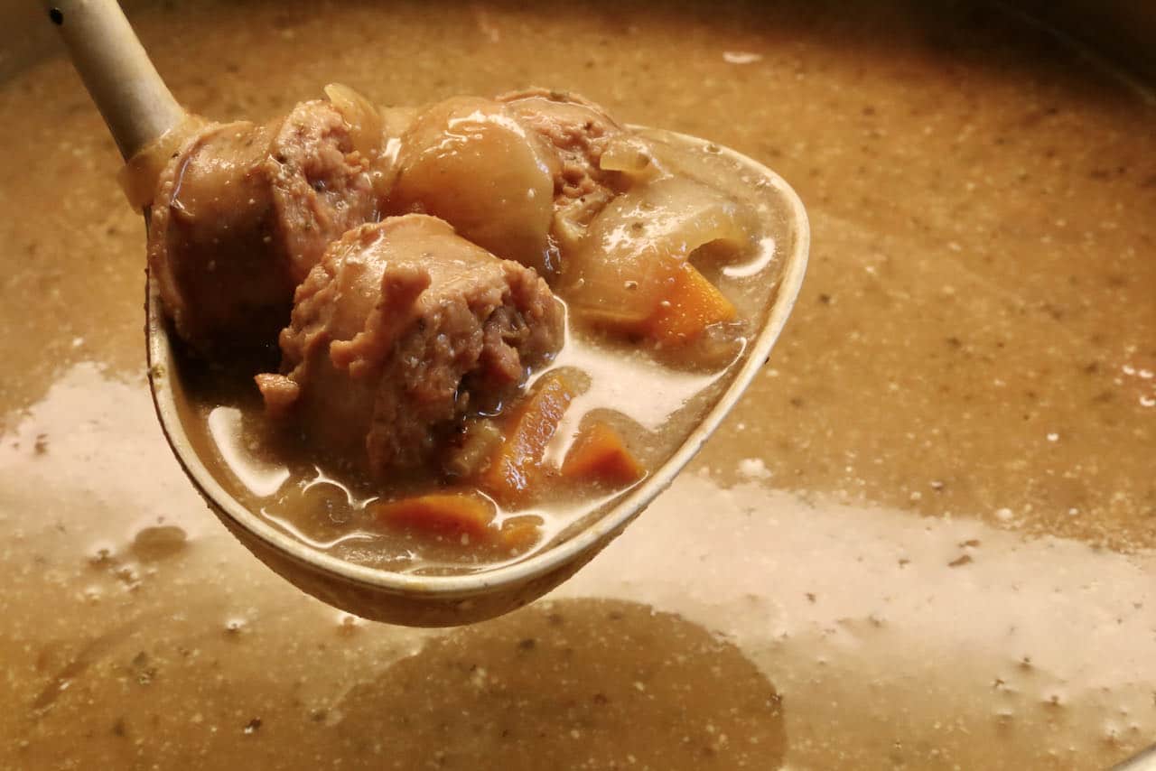 Slice Polish sausage and ladle into soup bowls.