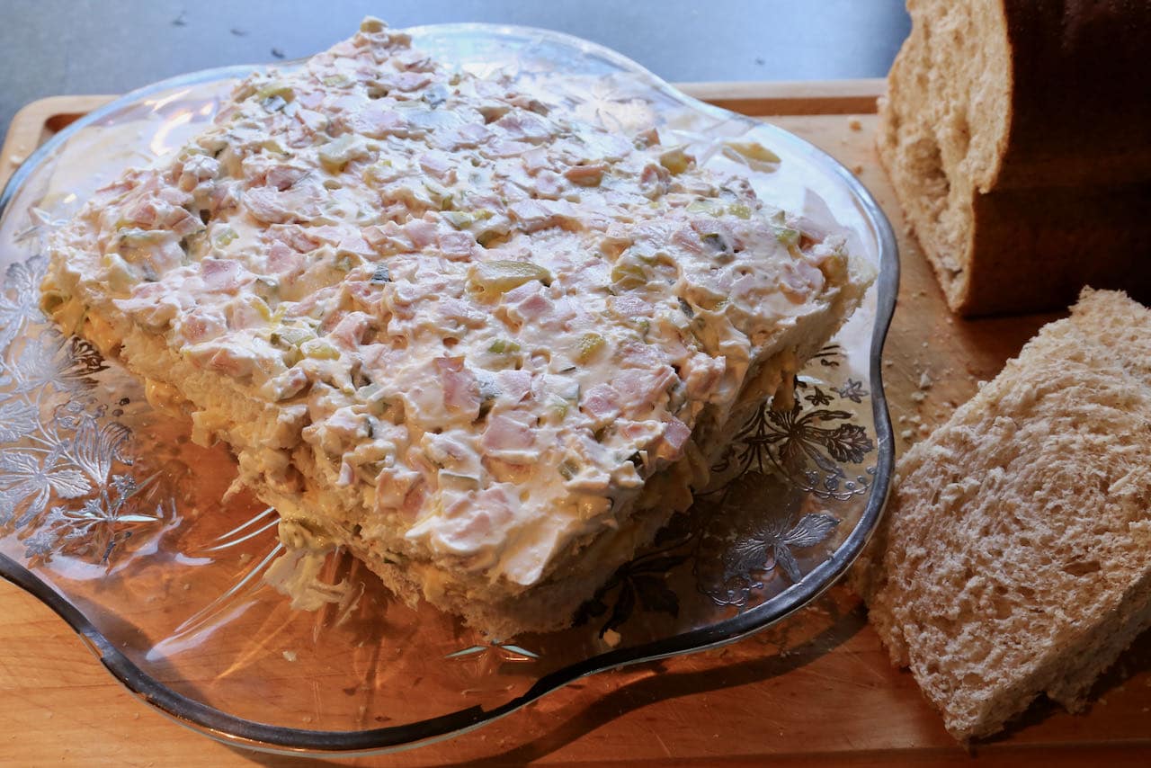 Layer Swedish Sandwich Cake with bread slices, egg salad and German ham & pickle filling.