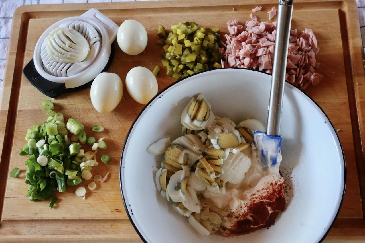 Start preparing Swedish Sandwich Cake by mixing together egg salad and ham & pickle fillings.