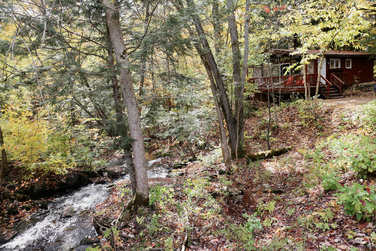 A scenic waterfall passes through Trillium Resort, a boutique Muskoka hotel in Port Sydney.