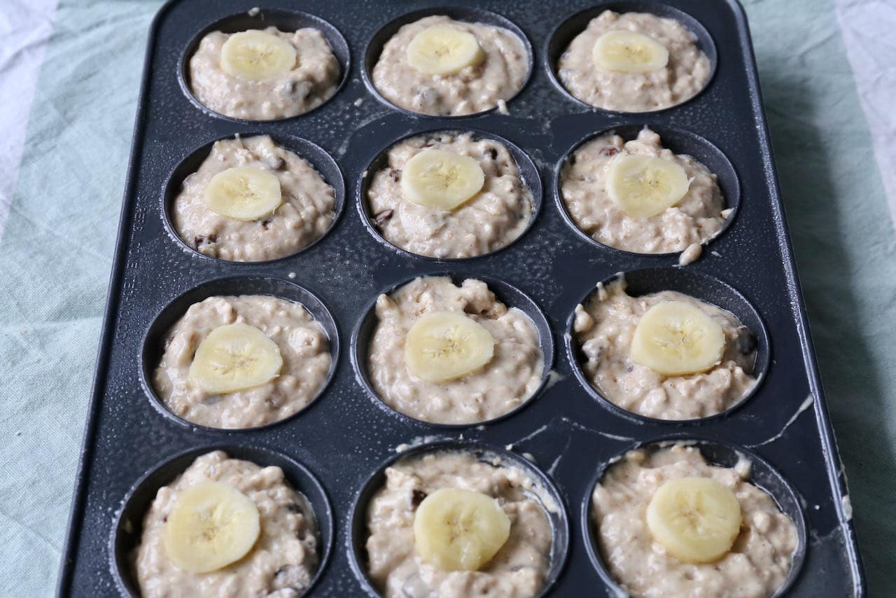 Top Buttermilk Banana Muffins with a slice of banana.