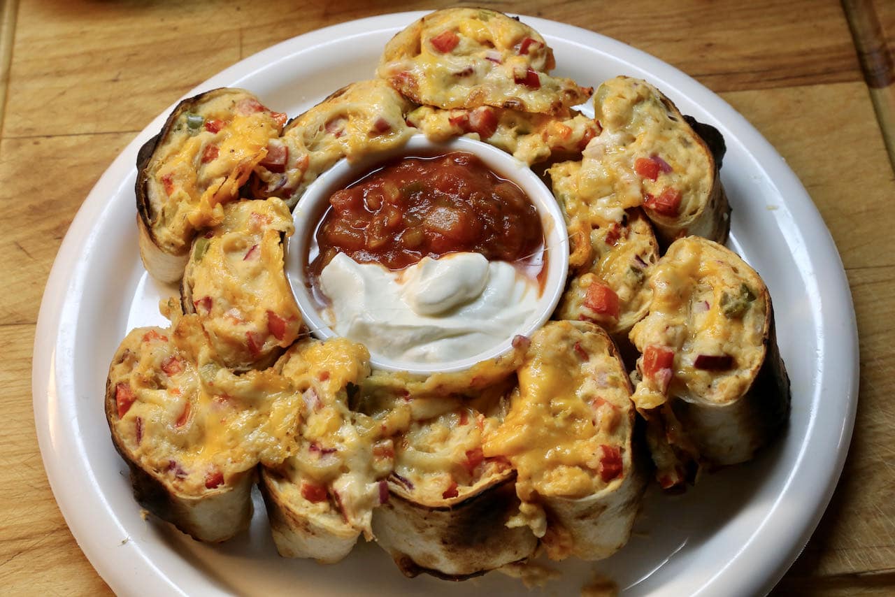 Serve our vegetarian Antojito recipe with sour cream and salsa.