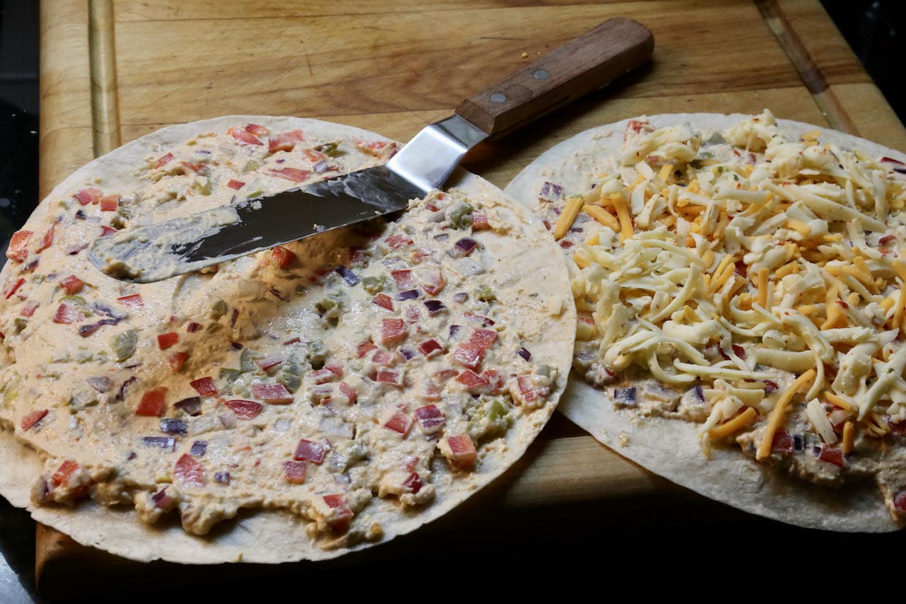 Slather tortilla with Antojito filling and sprinkle with shredded cheese.