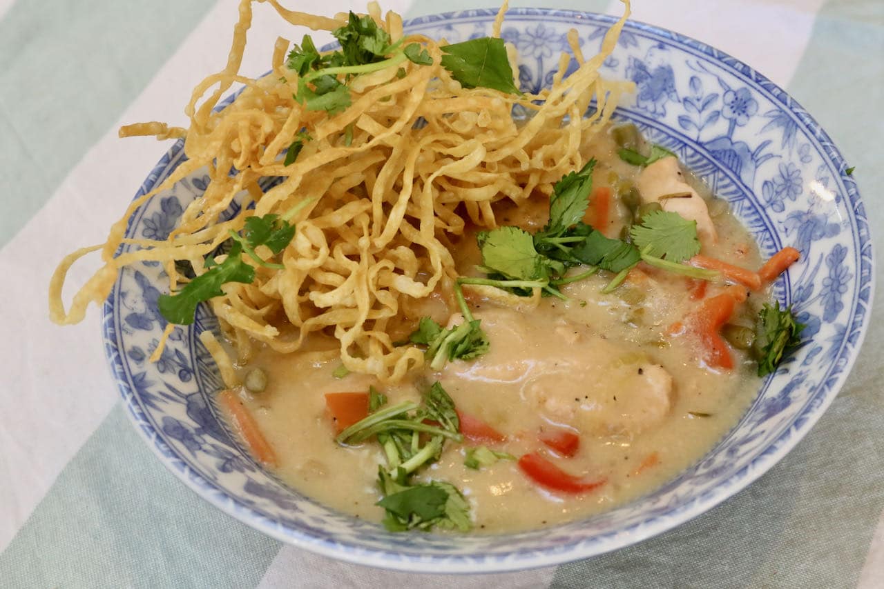 Chicken Manchow Soup offers a contrast of soft vegetables and chicken with crunchy fried noodles.