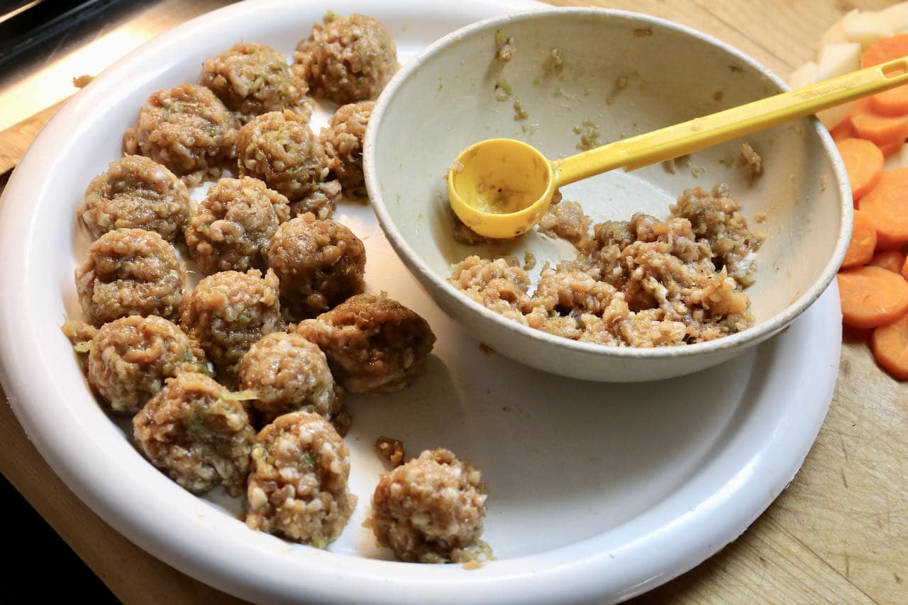 Use a melon baller to prepare uniformly sized plump pork meatballs.