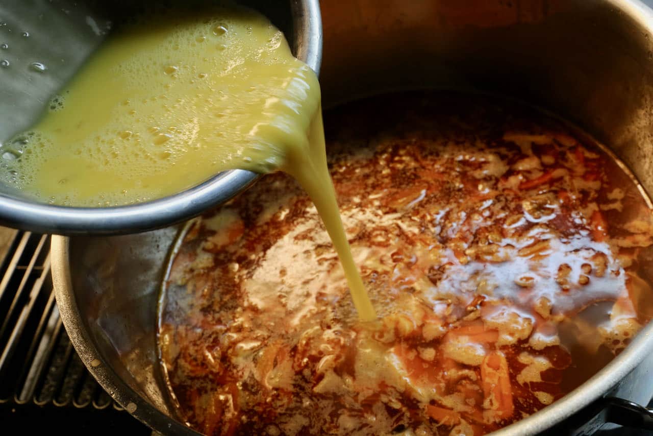 Add beaten eggs slowly to the hot pot of Spanish Soup broth.