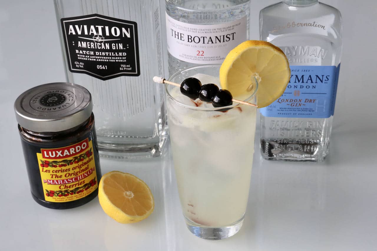 John Collins Drink ingredients include gin, lemon juice, simple syrup, soda and Maraschino Cherries.