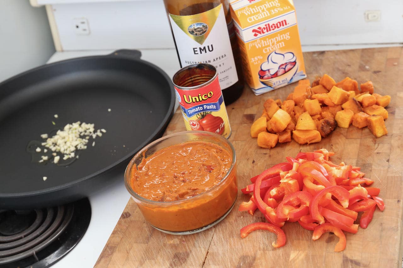 Prepare Harissa Pasta in a large skillet with garlic, peppers, squash and cream.