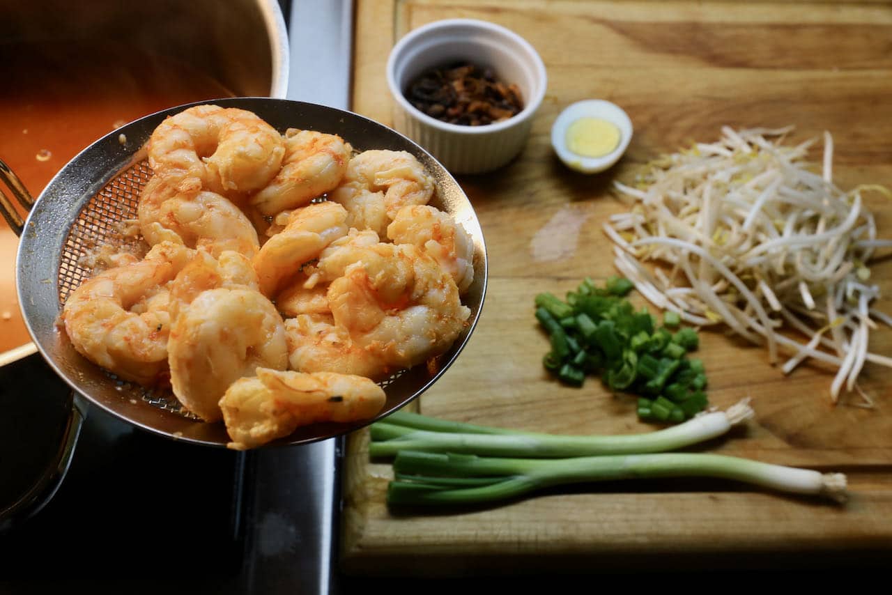 Poach prawns in soup broth then assemble recipe in soup bowls.