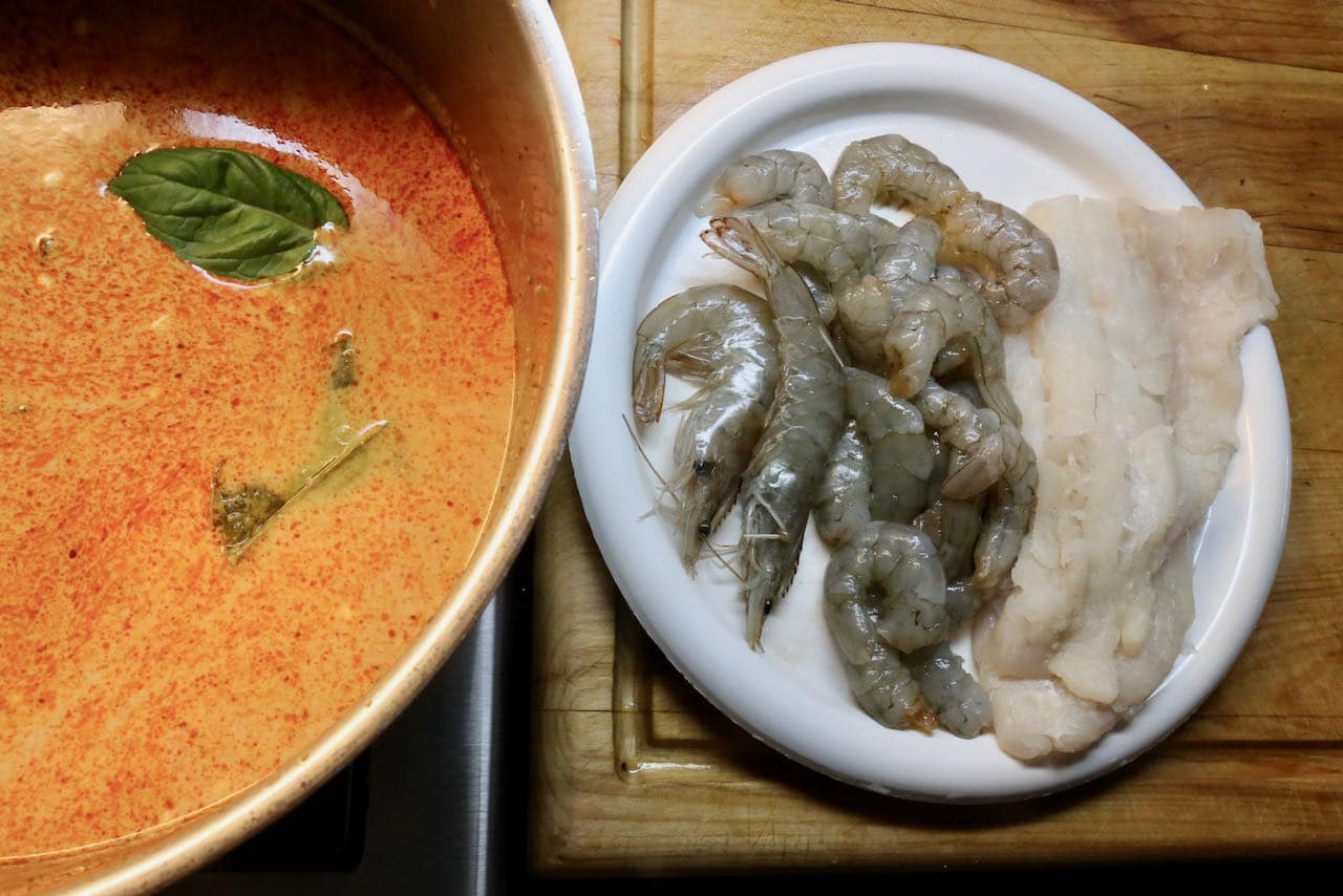 Homemade Seafood Laksa features prawns and white fish.