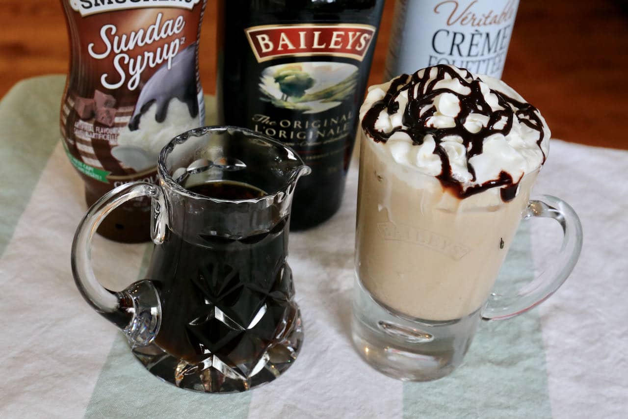 Baileys Iced Coffee is prepared with cold brewed coffee and is topped with whipping cream and chocolate sauce.