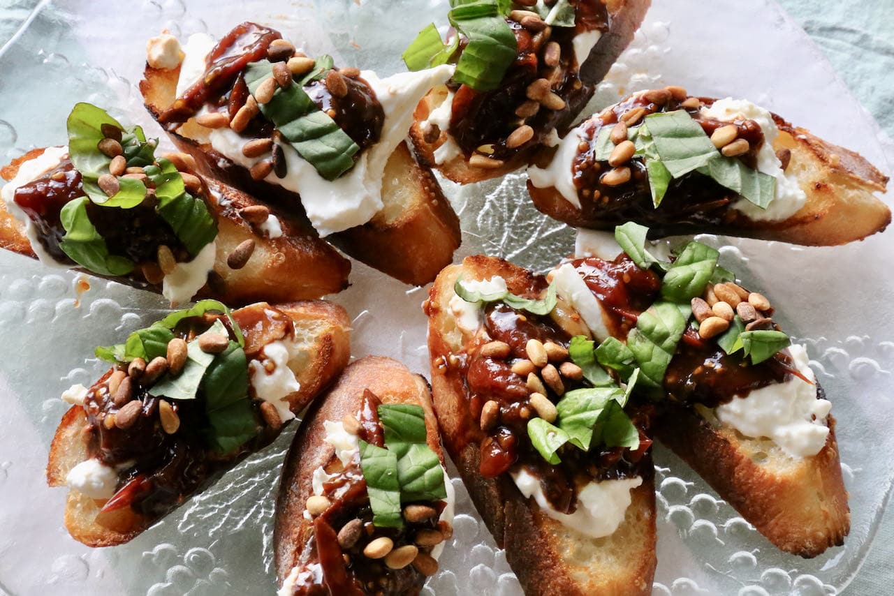 Serve Burrata Bruschetta Crostini on a platter at your next Italian dinner party.